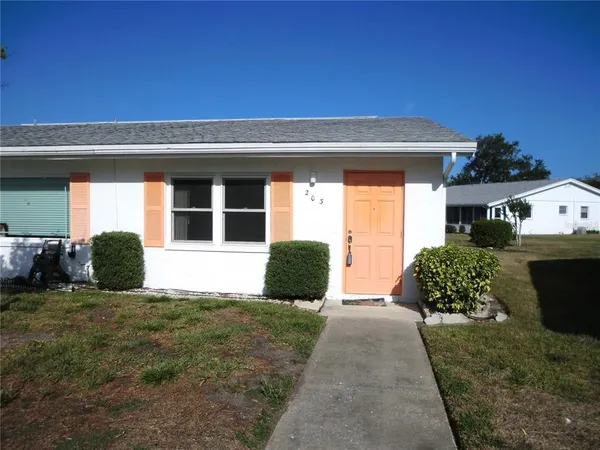 a view of a house with backyard and porch