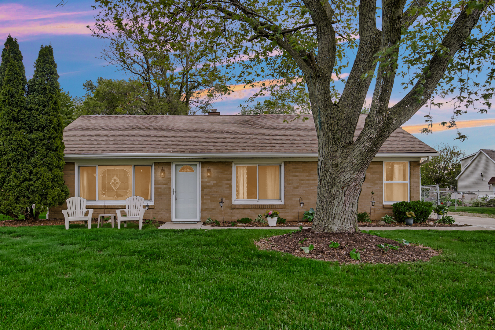 a front view of house with yard and green space