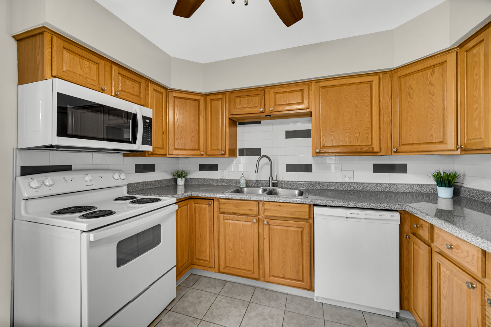 1455 Reckinger Road Aurora, IL 60505 - Photo 9 of 26 a kitchen with cabinets stainless steel appliances and a sink