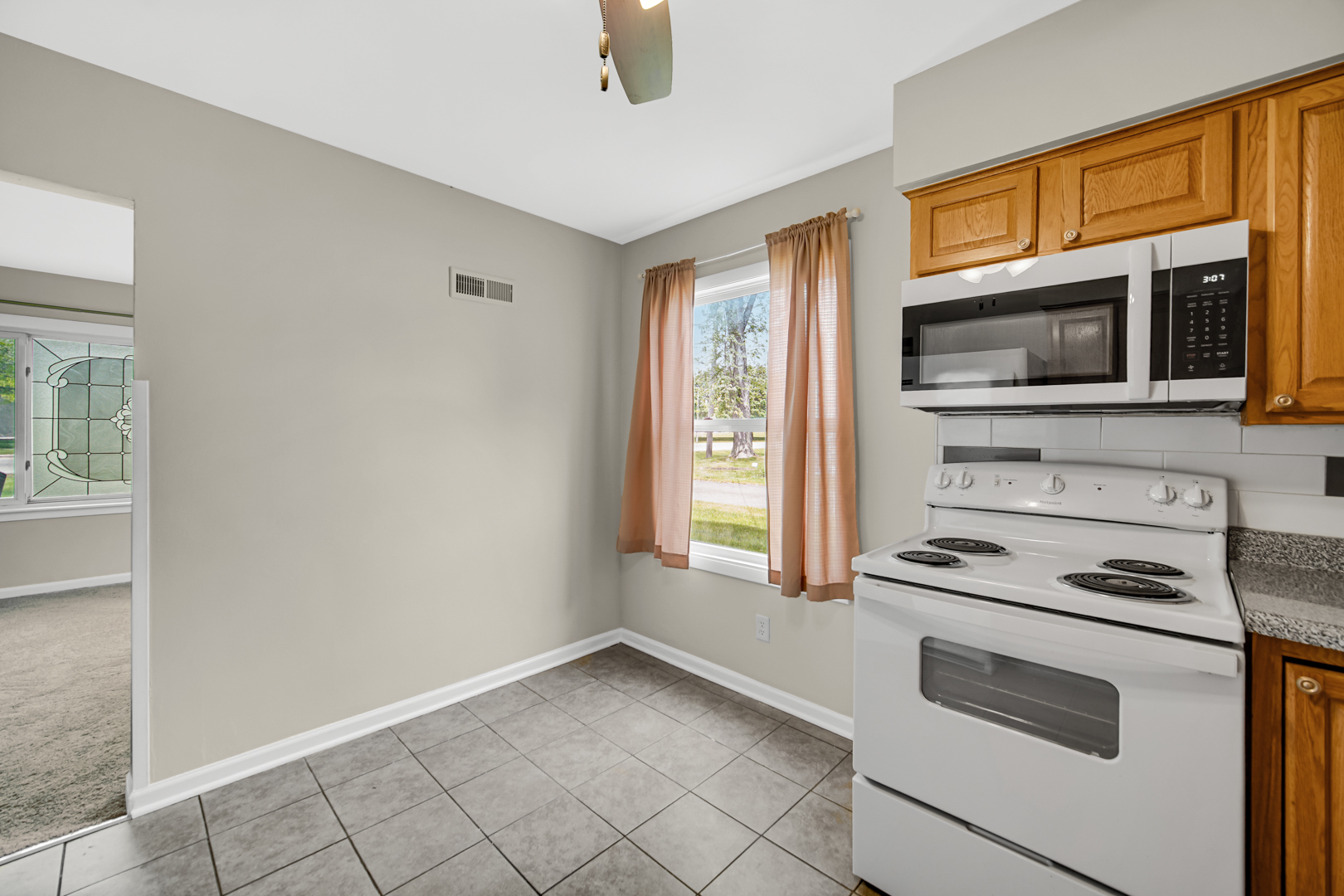 1455 Reckinger Road Aurora, IL 60505 - Photo 10 of 26 a kitchen with granite countertop cabinets stainless steel appliances and a window