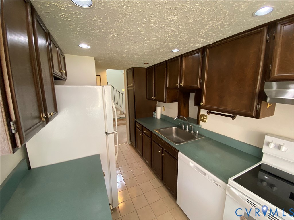 1507 Bronwyn Road, Unit 301 Henrico, VA 23238 - Photo 11 of 41 a kitchen with stainless steel appliances granite countertop a sink stove and refrigerator