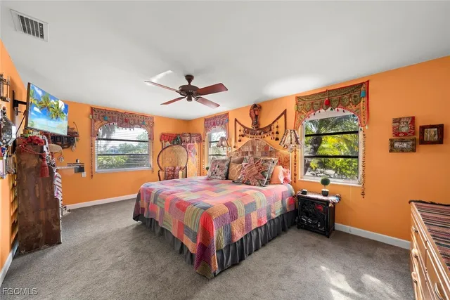 a bedroom with a bed and a large mirror with a flat screen tv