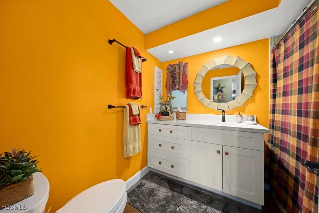 a bedroom with a bed chair and a large window