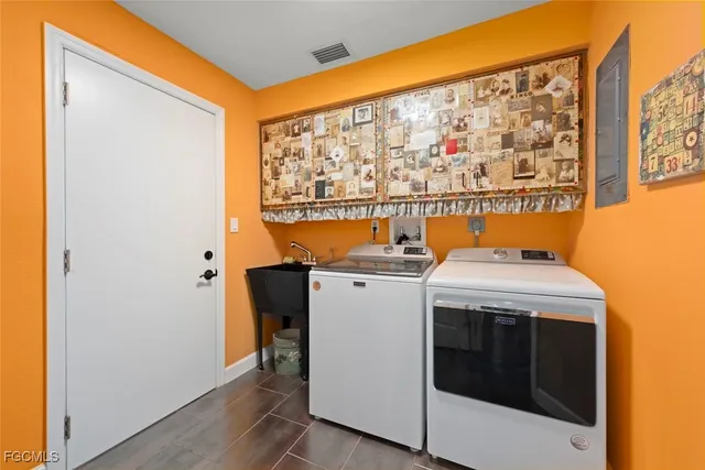 a blue swimming pool with table and chairs under an umbrella