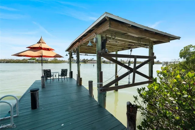 a view of a lake from deck and patio