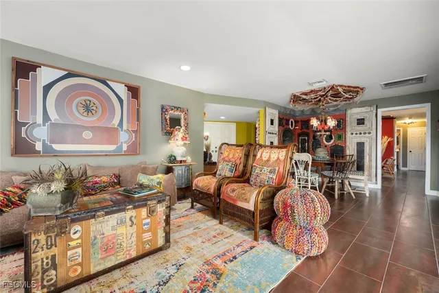 a living room with furniture and a book shelf