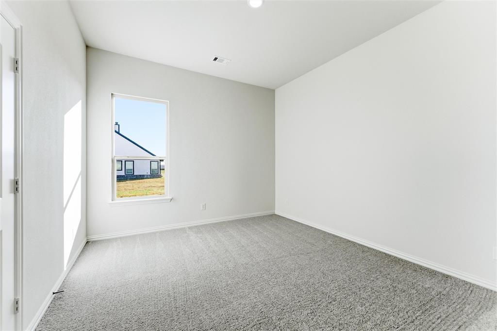 1030 County Road 200 Valley View, TX 76272 - Photo 19 of 27 Unfurnished room with light colored carpet and baseboards