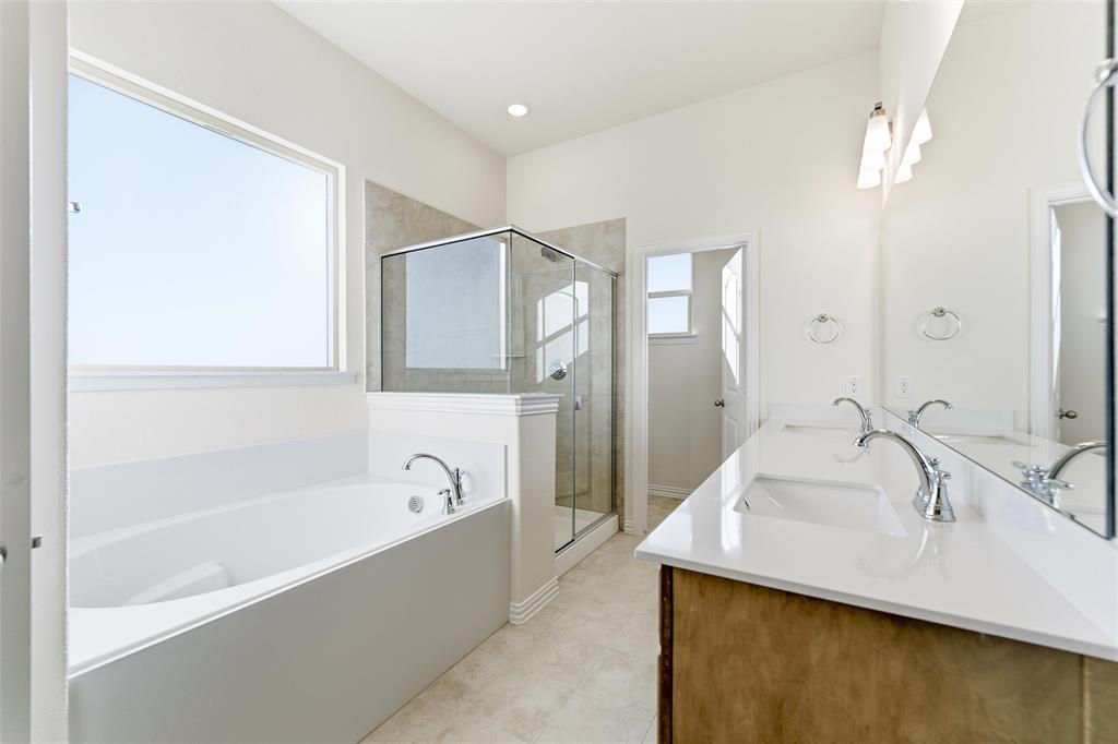 1030 County Road 200 Valley View, TX 76272 - Photo 22 of 27 Full bath with a bath, double vanity, a stall shower, and light tile patterned flooring