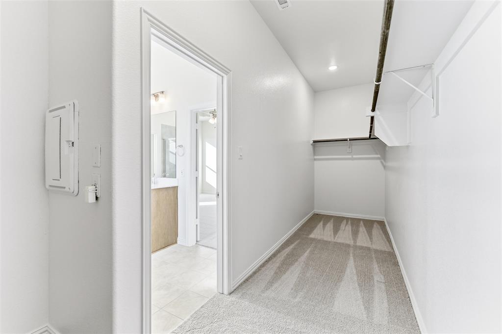 1030 County Road 200 Valley View, TX 76272 - Photo 23 of 27 Spacious closet with light colored carpet and electric panel