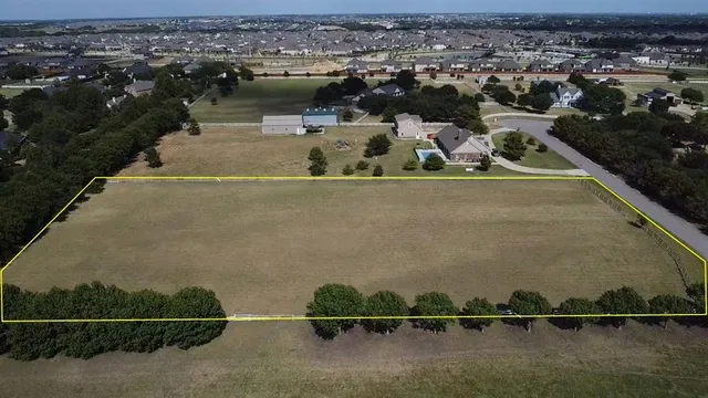 an aerial view of a house with a lake view