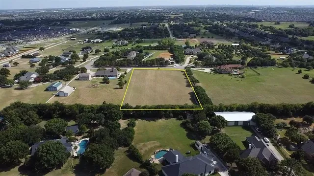 an aerial view of a house with a lake view