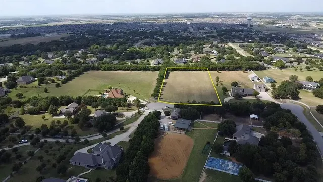 an aerial view of lake and residential houses with outdoor space
