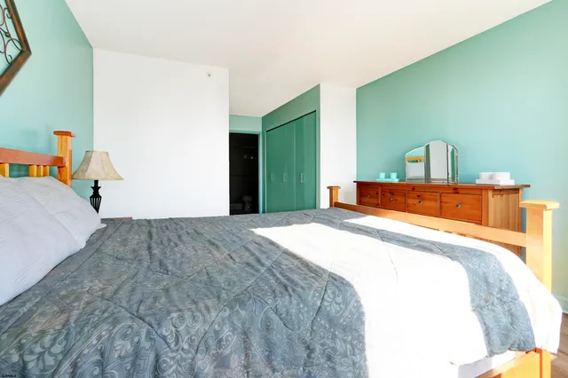 a bedroom with a bed and dresser