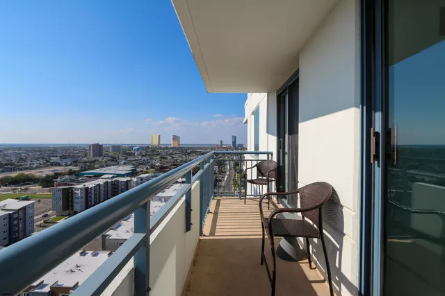 a balcony with wooden floor and city view
