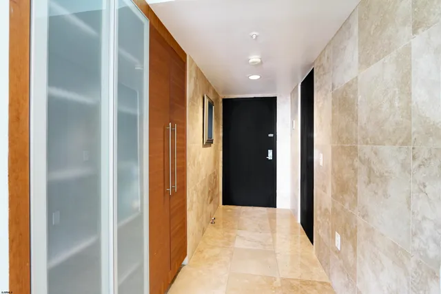 a view of a hallway with a wooden door