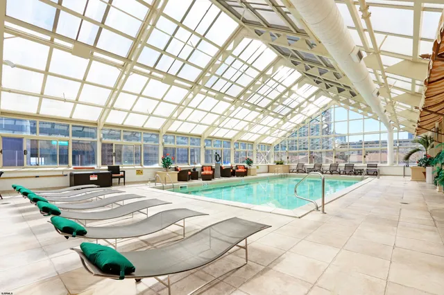 a view of a dining room with furniture and a potted plant