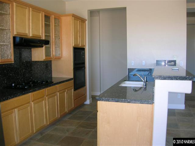 513 Spirit Ridge Court Reno, NV 89511 - Photo 6 of 13 a kitchen with stainless steel appliances granite countertop a sink and a refrigerator