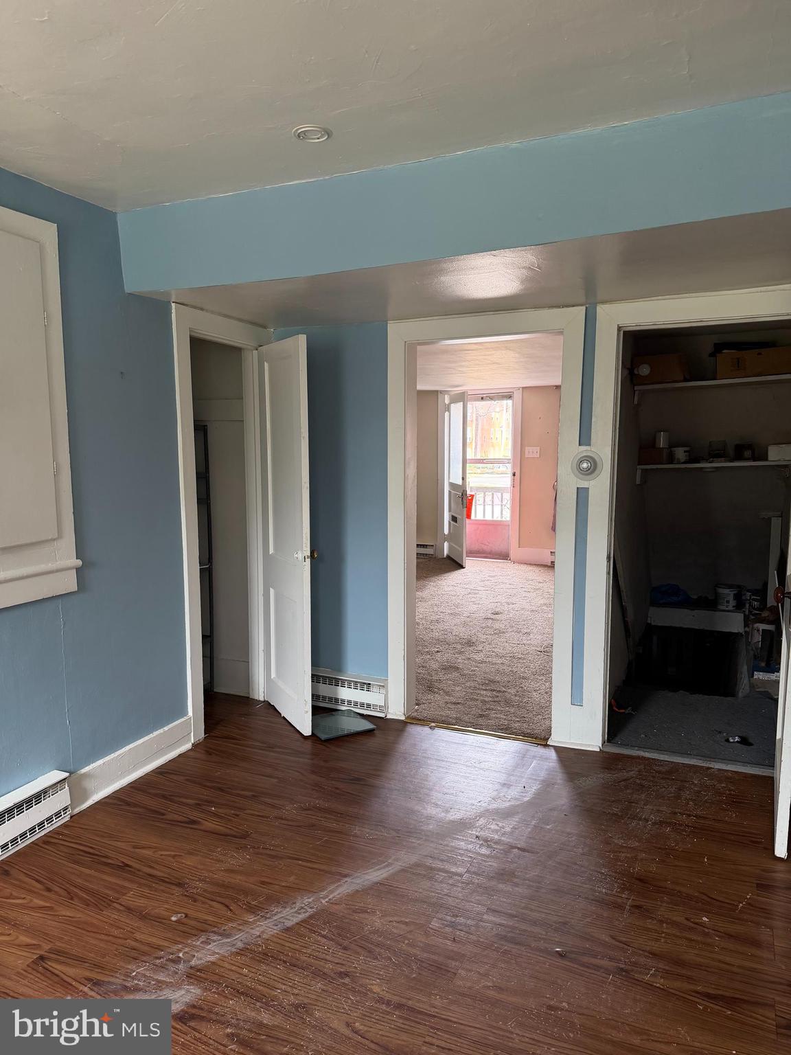 284 West State Street Doylestown, PA 18901 - Photo 3 of 11 an empty room with wooden floor and way to kitchen