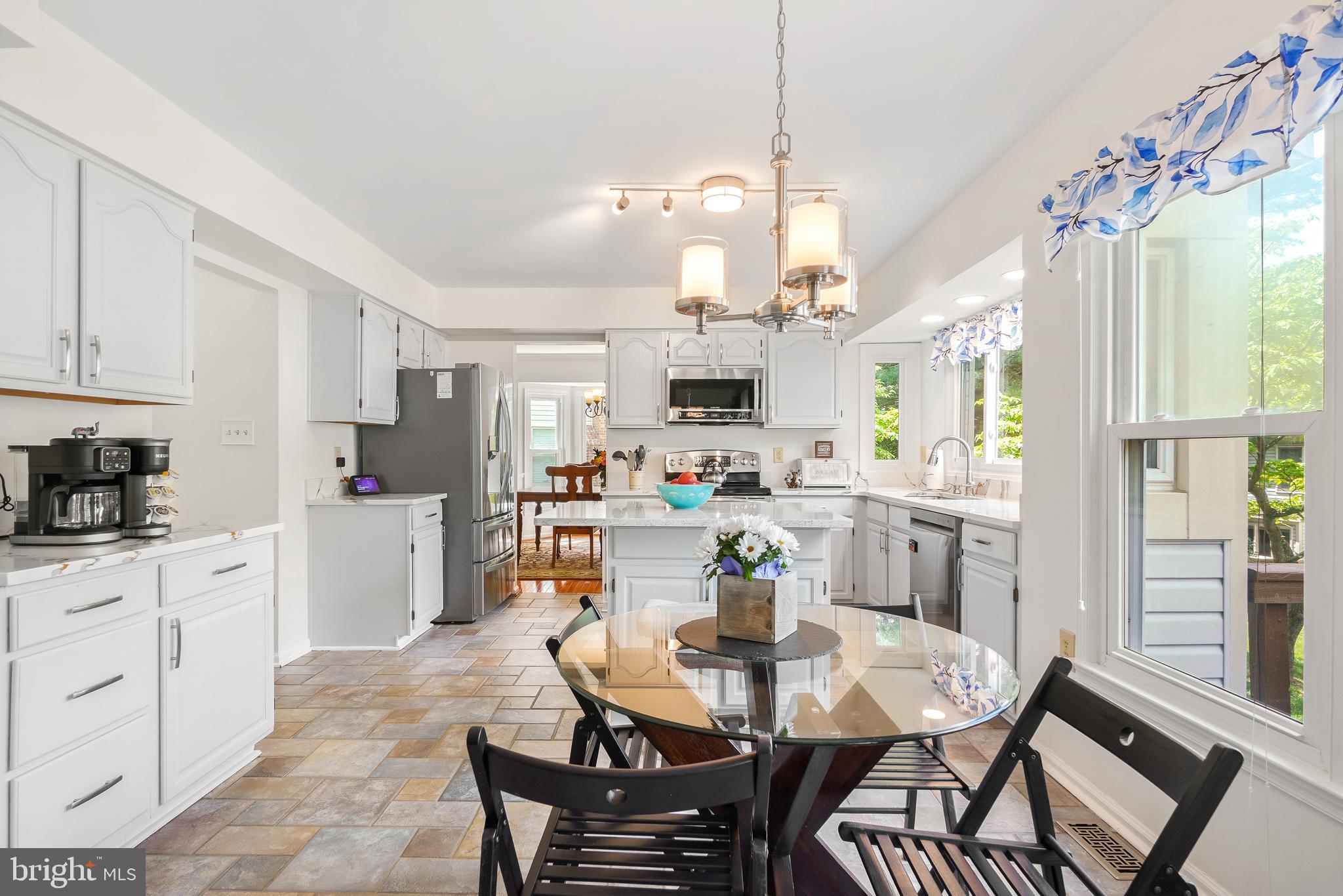 130 Englefield Drive Gaithersburg, MD 20878 - Photo 14 of 33 a view of a dining room and livingroom with furniture wooden floor a chandelier