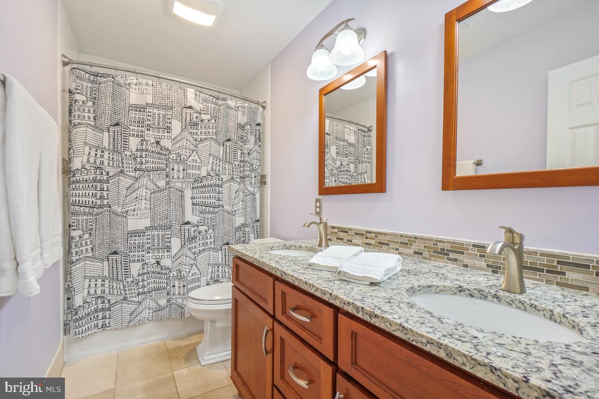 130 Englefield Drive Gaithersburg, MD 20878 - Photo 20 of 33 a bathroom with a granite countertop sink a toilet and a mirror