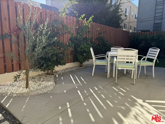 a view of a chairs and table in the patio