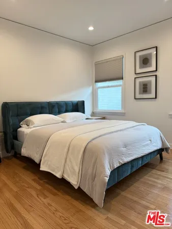 a bedroom with a bed and a night stand