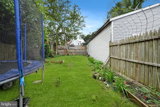 a view of a chairs and table in backyard
