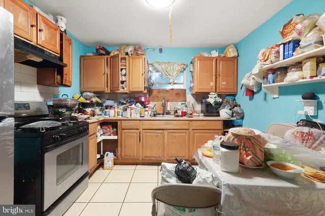 a kitchen with stainless steel appliances a stove a sink and a refrigerator