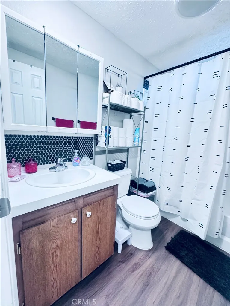 250 North Linden Avenue, Unit 250 Rialto, CA 92376 - Photo 16 of 29 a bathroom with a sink toilet and shower