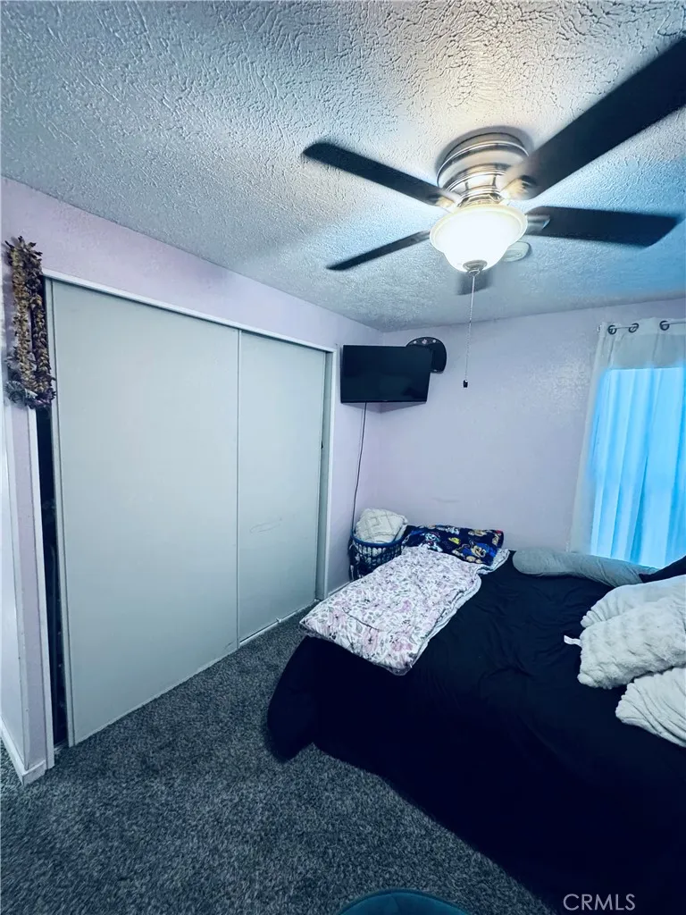 250 North Linden Avenue, Unit 250 Rialto, CA 92376 - Photo 20 of 29 a bed room with furniture and a chandelier