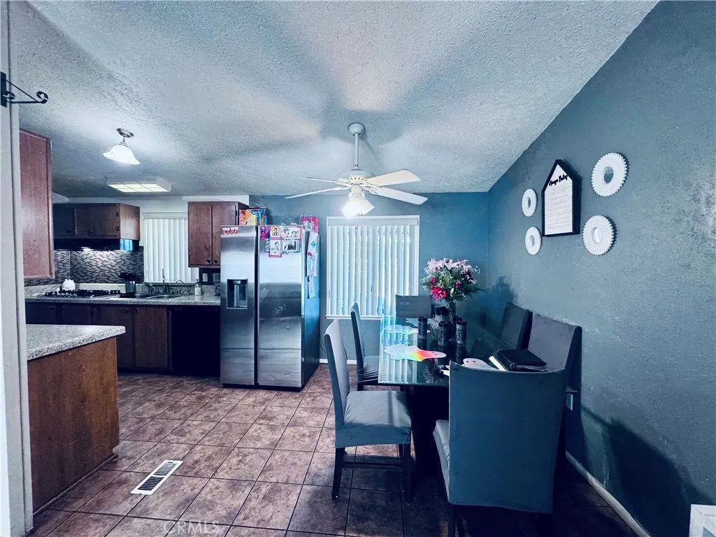 250 North Linden Avenue, Unit 250 Rialto, CA 92376 - Photo 10 of 29 a view of kitchen with refrigerator stove microwave and dining table