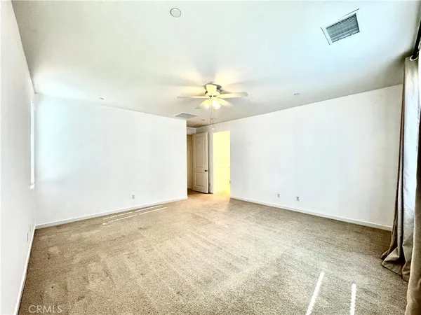 an empty room with windows and closet