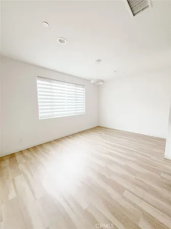a view of a kitchen with kitchen island a sink wooden floor and counter top space