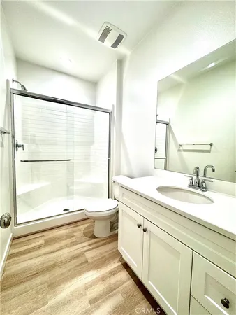 an empty room with windows and ceiling fan