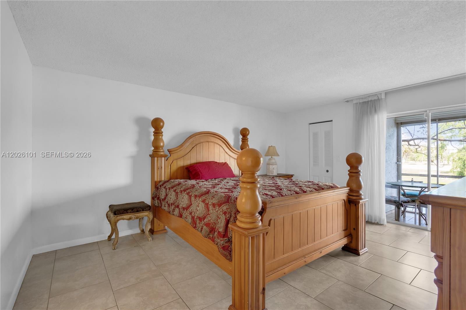 3551 Inverrary Drive, Unit 208 Lauderhill, FL 33319 - Photo 8 of 34 a bedroom with a bed and a table in it