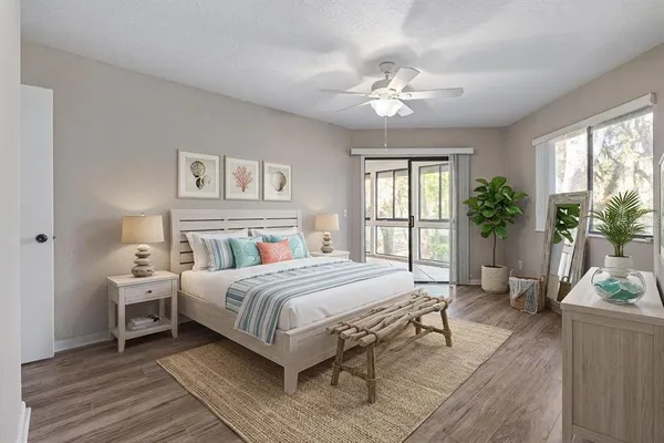 a bedroom with a large bed and a chandelier