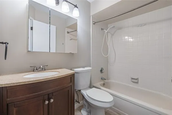 a bathroom with a sink toilet vanity and shower