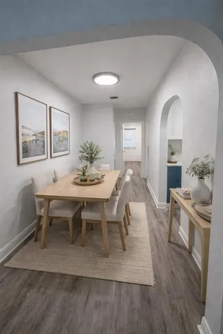 a view of a dining room with furniture and wooden floor