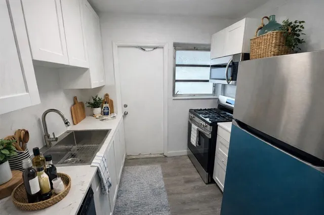 a kitchen with a sink appliances and cabinets