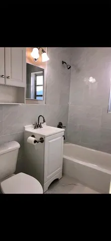 a bathroom with a sink a toilet and bathtub