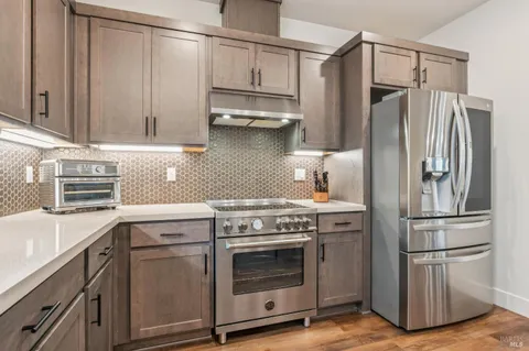 a kitchen with appliances cabinets and a counter top space