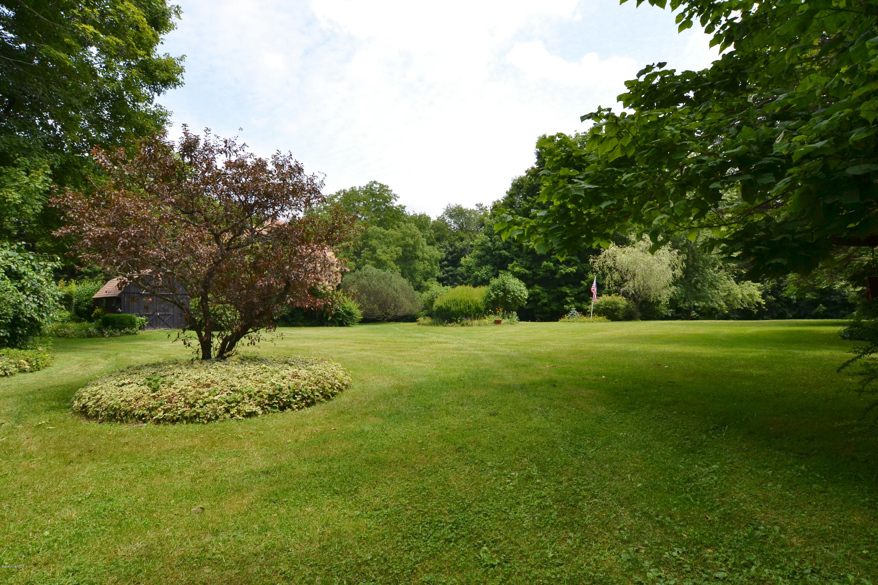 1691 Dublin Road Richmond, MA 01254 - Photo 7 of 35 a garden with trees in the background