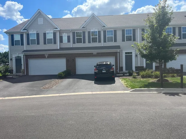 a view of a house with a yard and plants