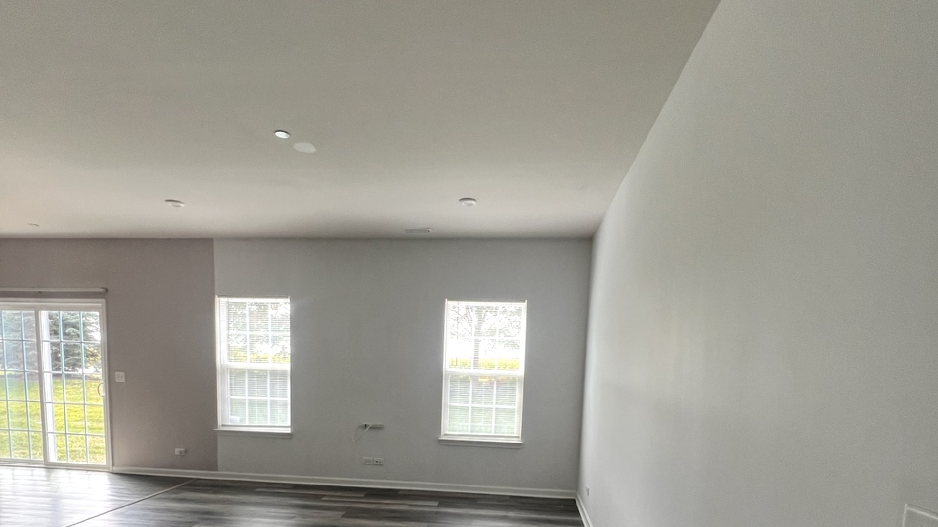 3423 Helene Rieder Drive, Unit 3423 Montgomery, IL 60538 - Photo 4 of 9 an empty room with wooden floor and windows