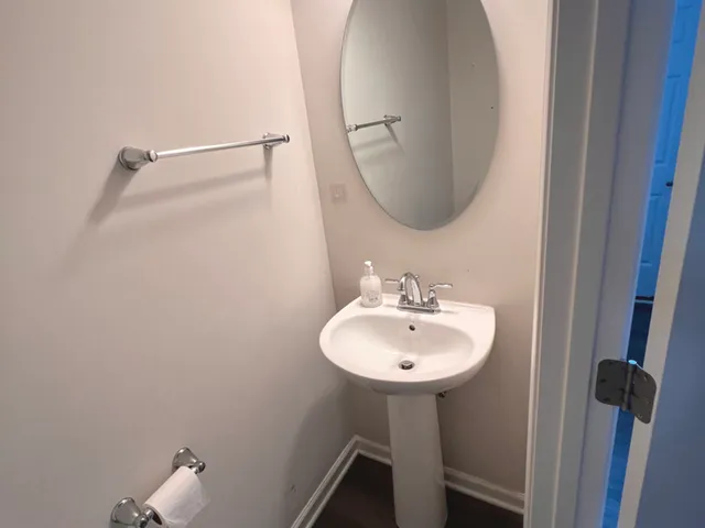 a bathroom with a sink a mirror and a vanity