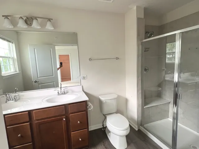 a bathroom with a sink toilet and shower