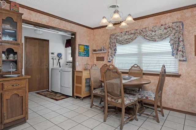 a view of a dining room with furniture and chandelier