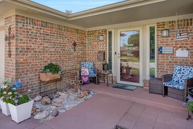 a lobby with furniture and a potted plant