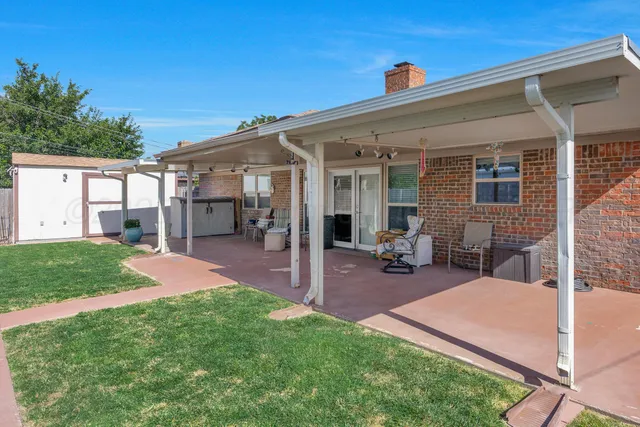 a view of a house with backyard porch and sitting area