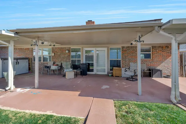a view of a house with backyard porch and sitting area